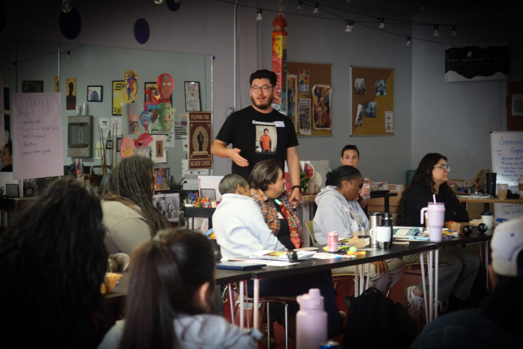 Action shot of Open Doors facilitator Francisco Valverde training the staff of Waking the Village in Sacramento