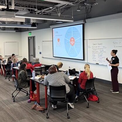 Open Doors facilitator Kat Besse presents in front of an audience