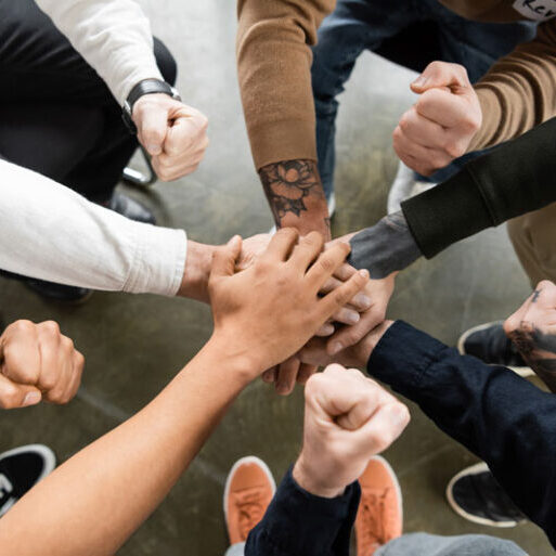 many hands, stacked before group cheer