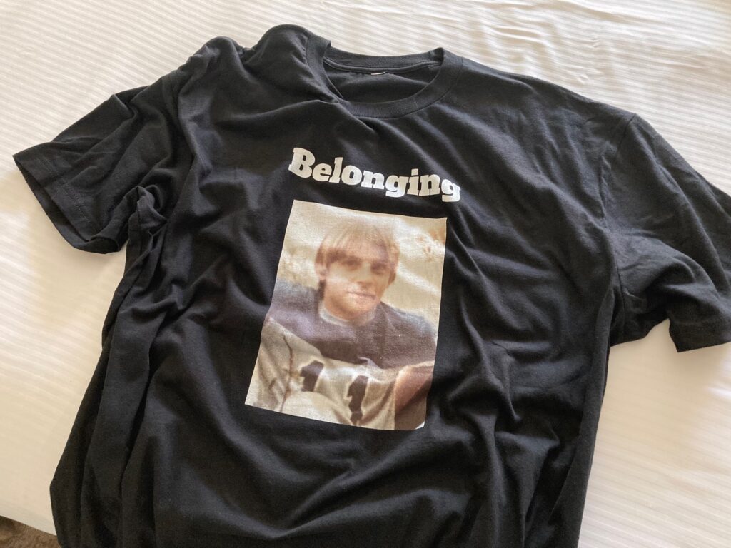 Open Doors Senior Facilitator James Freeman's t-shirt showing him as a youth with the word "belonging" above his image